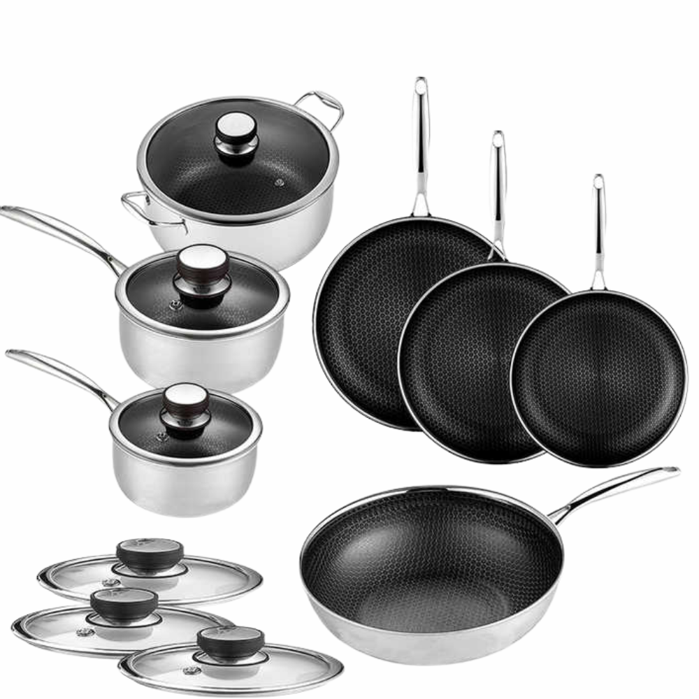 Stainless steel honeycomb cookware set with saucepots, frying pans and glass lids on a wooden table. 