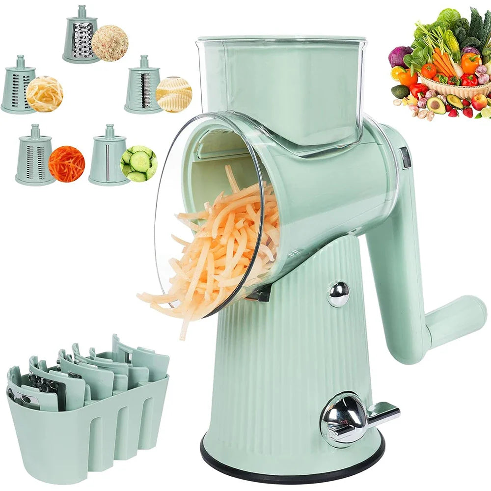 Sage green rotary cheese grater in action shredding carrots, with 5 interchangeable stainless steel drum blades, blade storage caddy, and fresh vegetables on white background