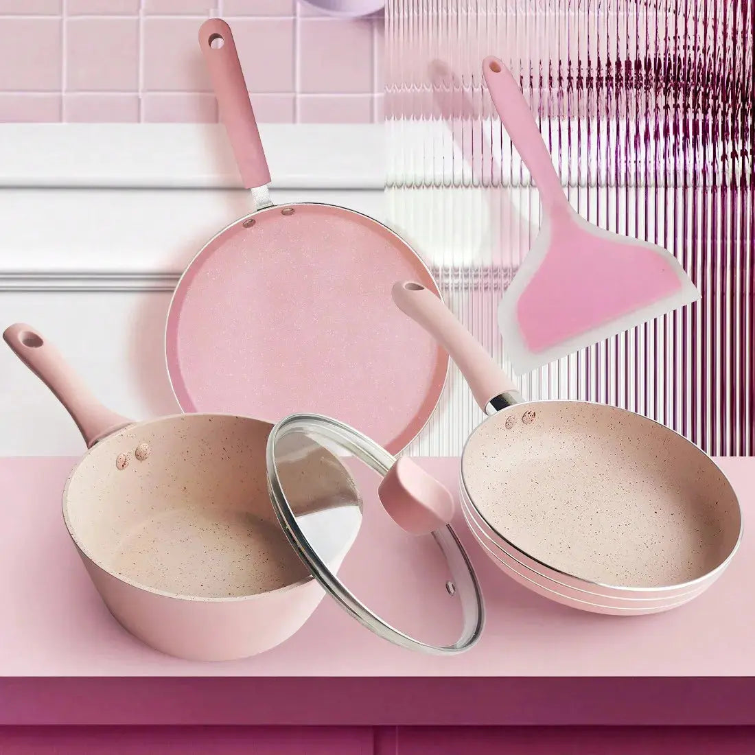 Elegant blush pink cookware set with utensils, styled for modern kitchen collections