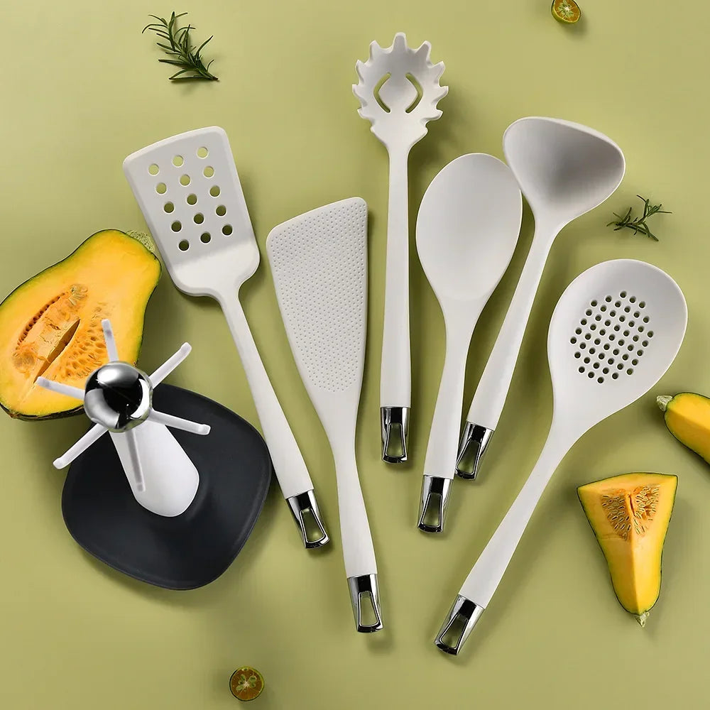 7-Piece Silicone Kitchen Utensils Set with 360° Rotating Countertop Holder – White silicone heads and handles with silver-tone stainless steel hanging hooks/end caps. Heat-Resistant, Dishwasher Safe