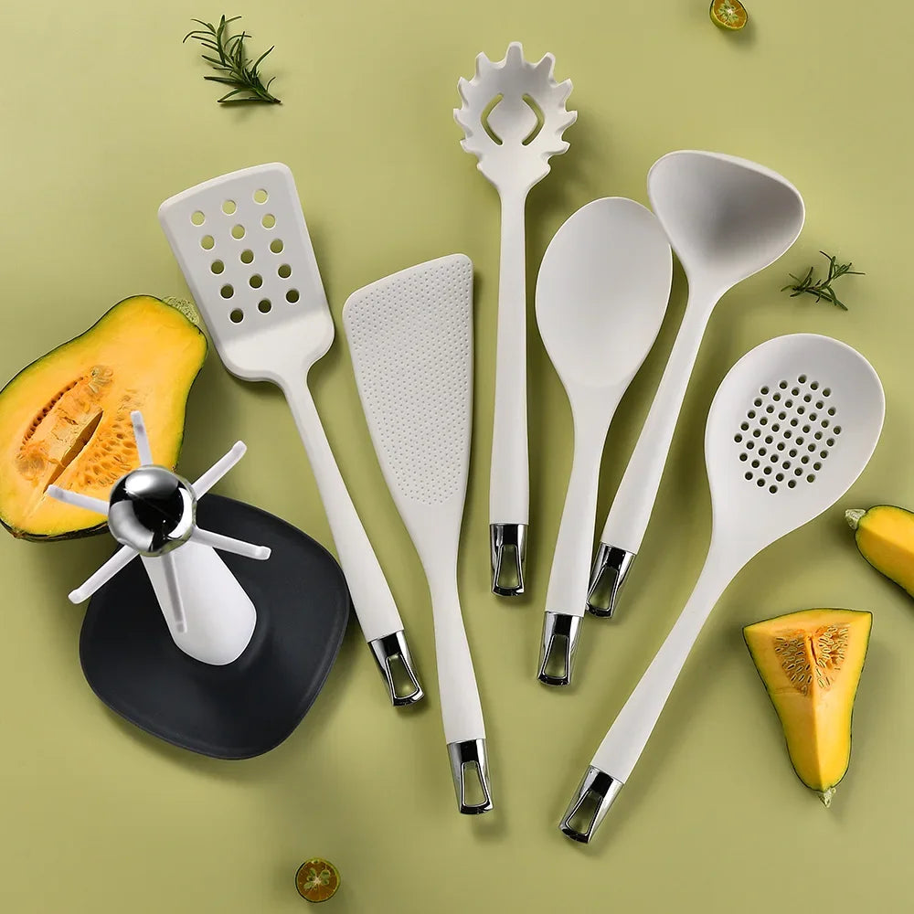 7-Piece Silicone Kitchen Utensils Set with 360° Rotating Countertop Holder – White silicone heads and handles with silver-tone stainless steel hanging hooks/end caps. Heat-Resistant, Dishwasher Safe